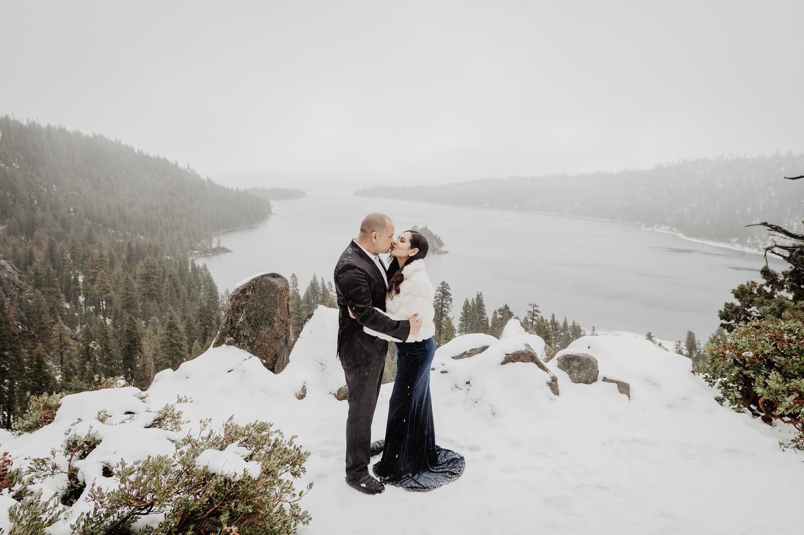 Outdoor winter elopement of a bride and groom both wearing black among the snow in Lake Tahoe