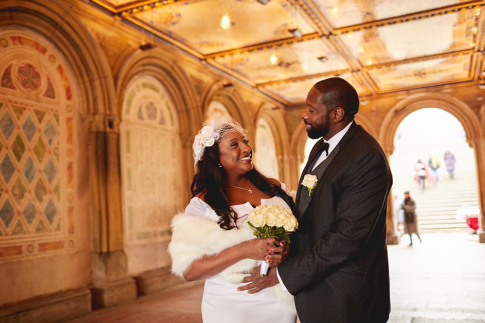 A bride and groom after their elopement at Bethesda Arcade in Central Park, New York City.