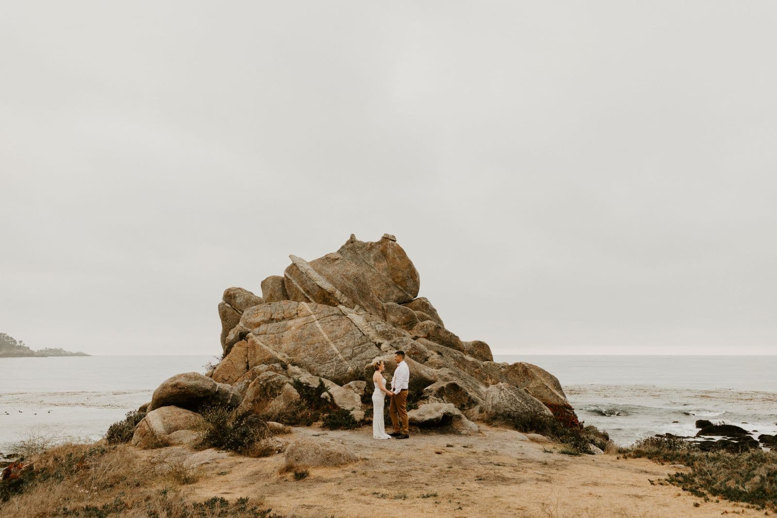 A bride and groom exchanging vows during their elopement ceremony at Wedding Rock in Big Sur.