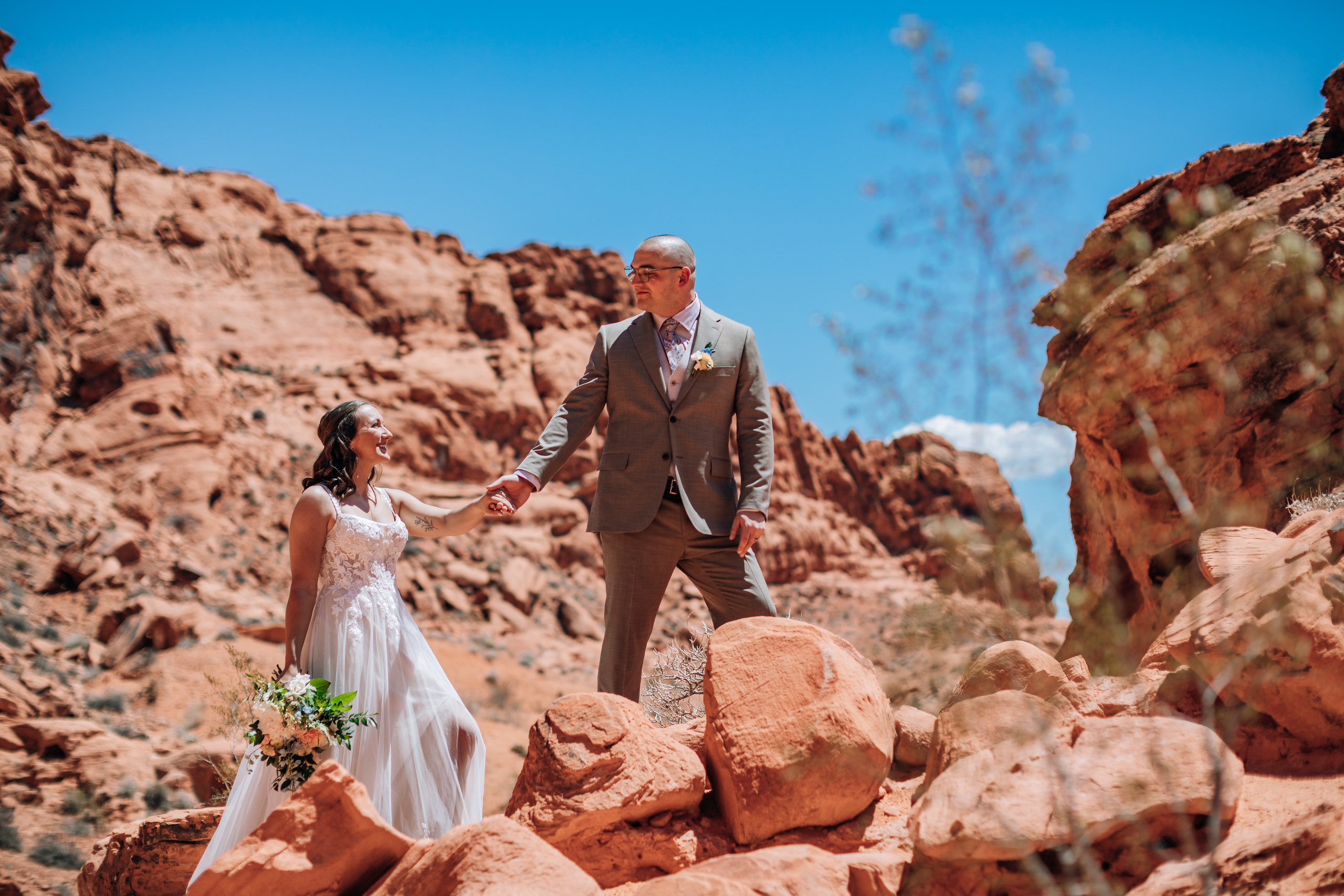 A bride and groom post after their elopement ceremony at Visitors Center in Las Vegas, Nevada