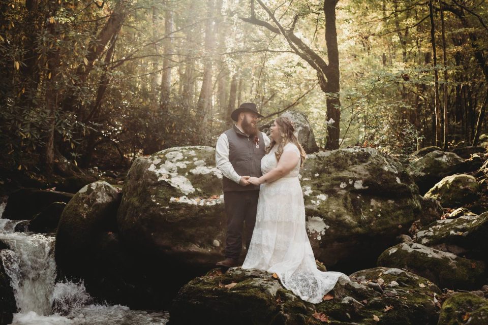 Bride and groom pose in the forest after their elopement ceremony