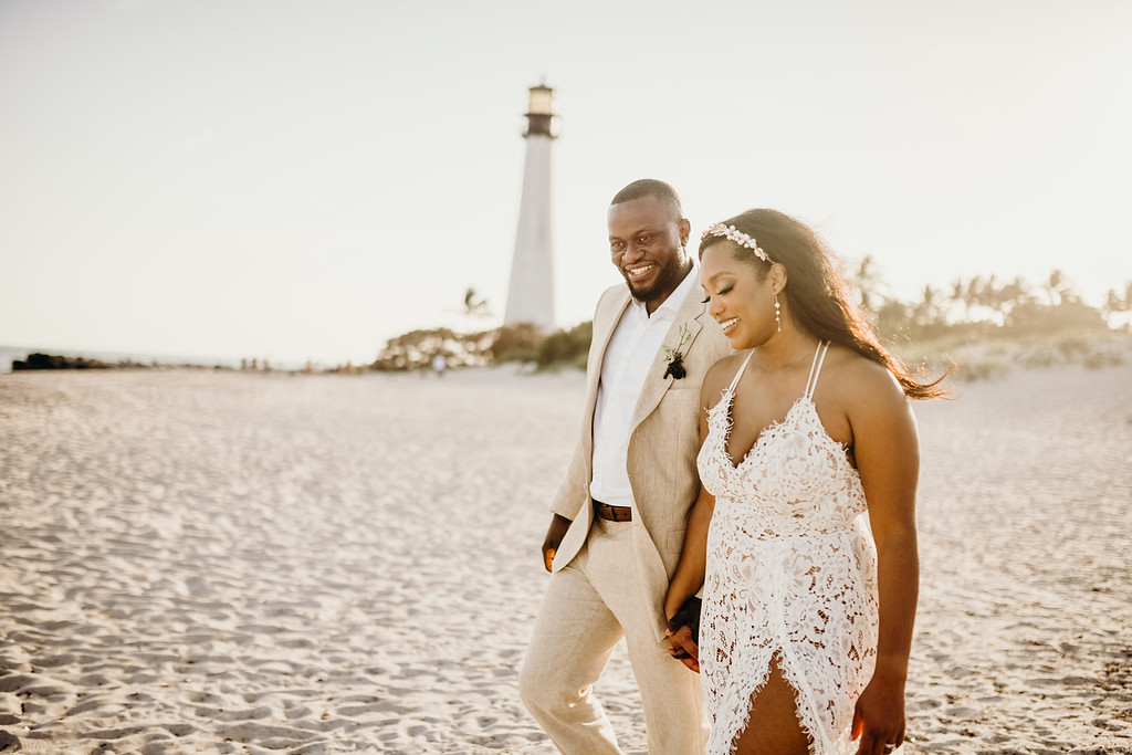 Couple walks on the beach after their intimate elopement.